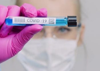 Researcher Holding Covid-19 Sample Tube In Hand
