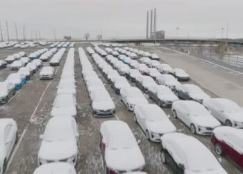 VideoHive Snow covered cars low flying in with reveal of car assembly plant 44517673