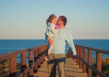 VideoHive A Happy Father Carries His Little Daughter in His Arms and Kisses Her Happy Fatherhood Happy 50413131